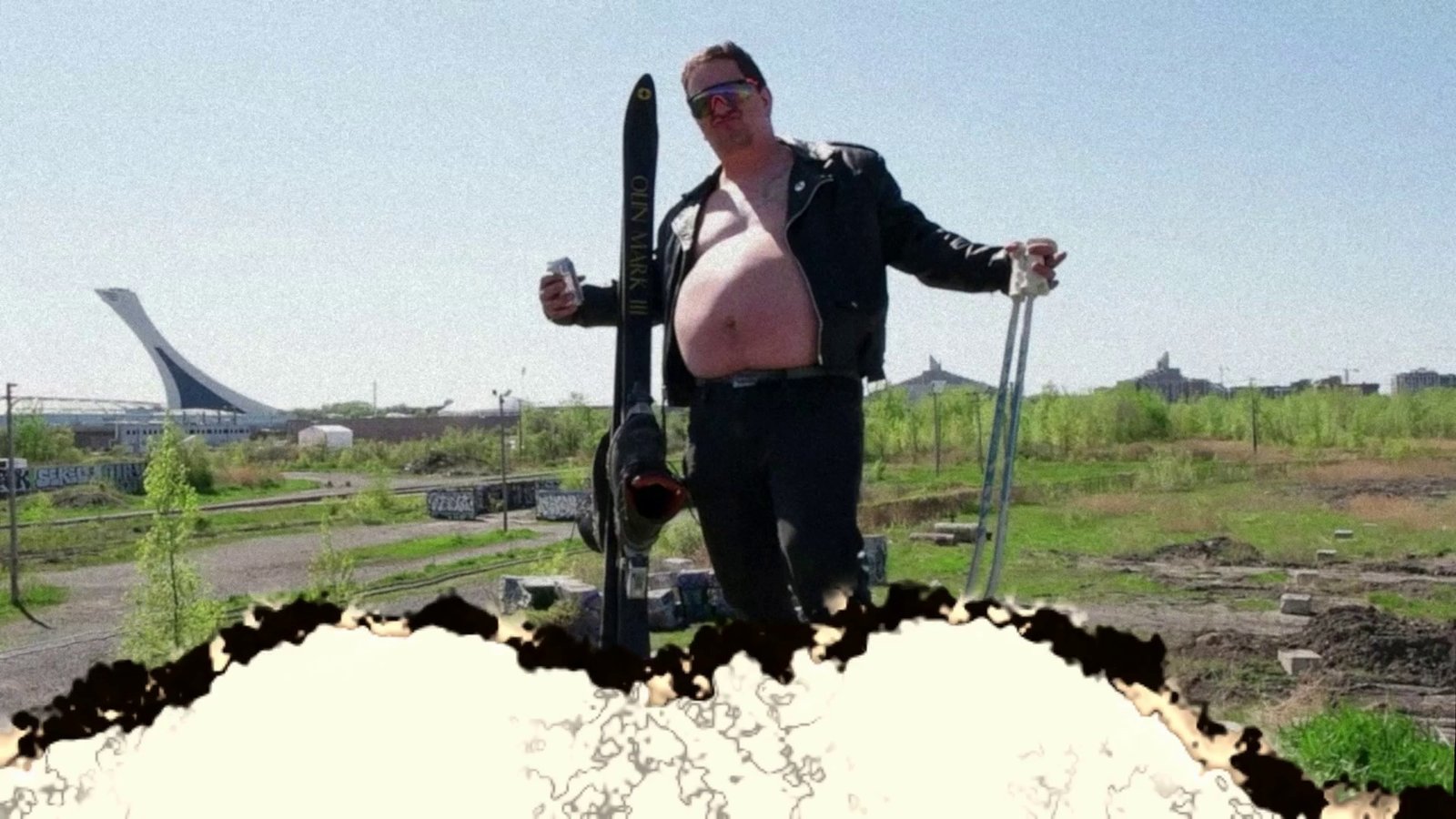 Daylight footage: a skier posing on a dirt lot with a stadium behind. After Super8 Film Lab, burned look: a burn event with tears and flicker.